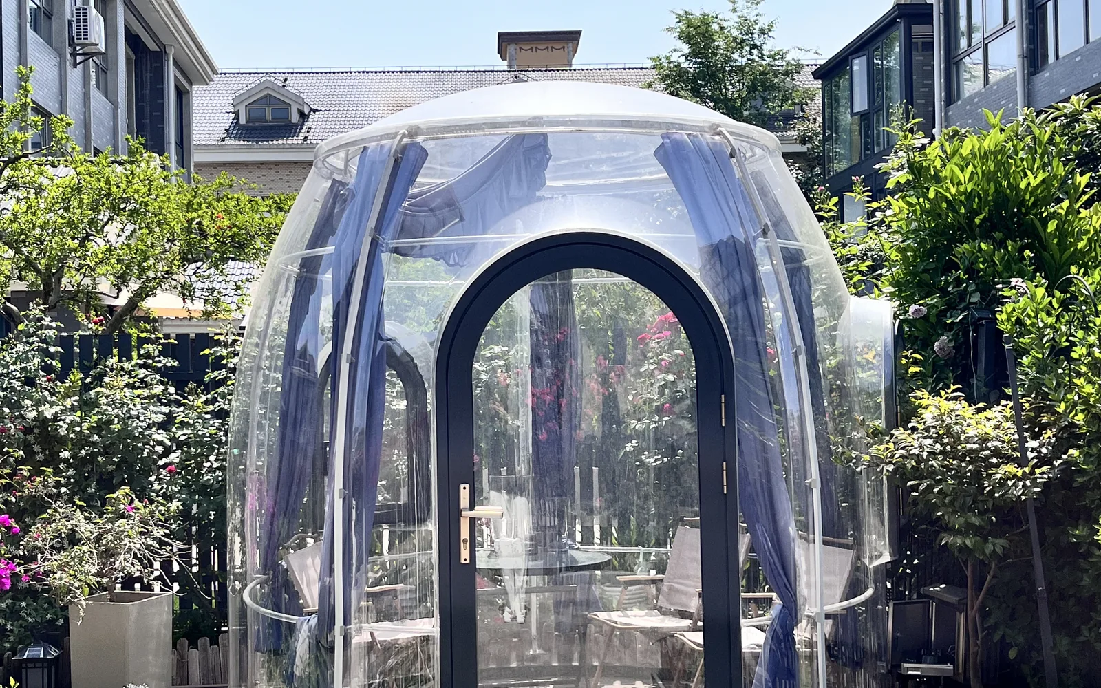 Compact transparent Celenest dome installed beside a residential garden