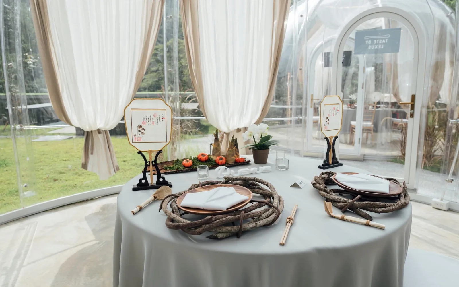 Round dining table prepared inside a transparent dome