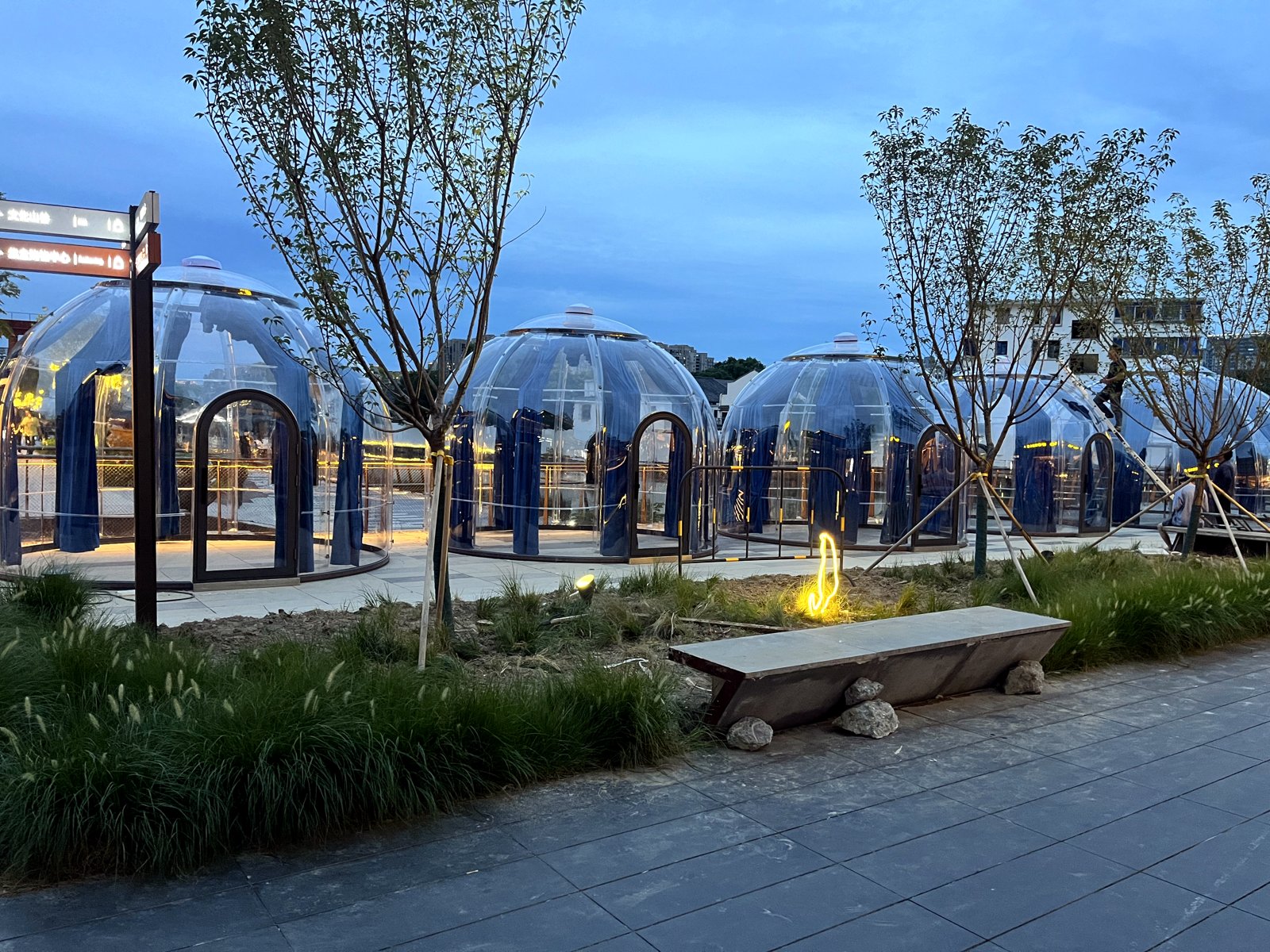 Row of Celenest dining domes at blue hour