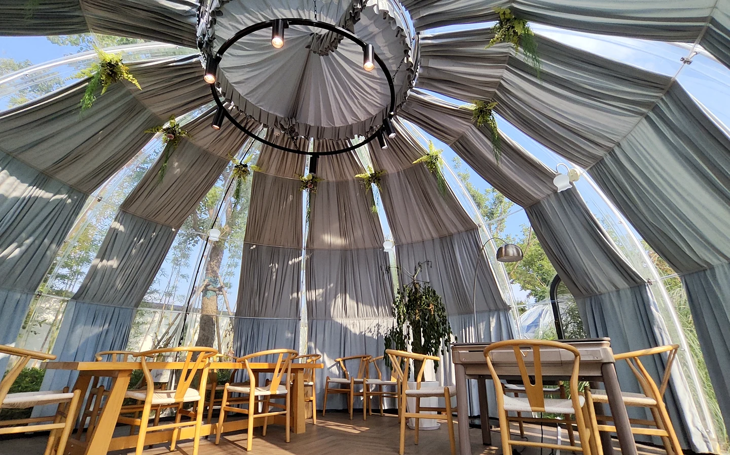 Dining seating and drapes inside a Celenest dome