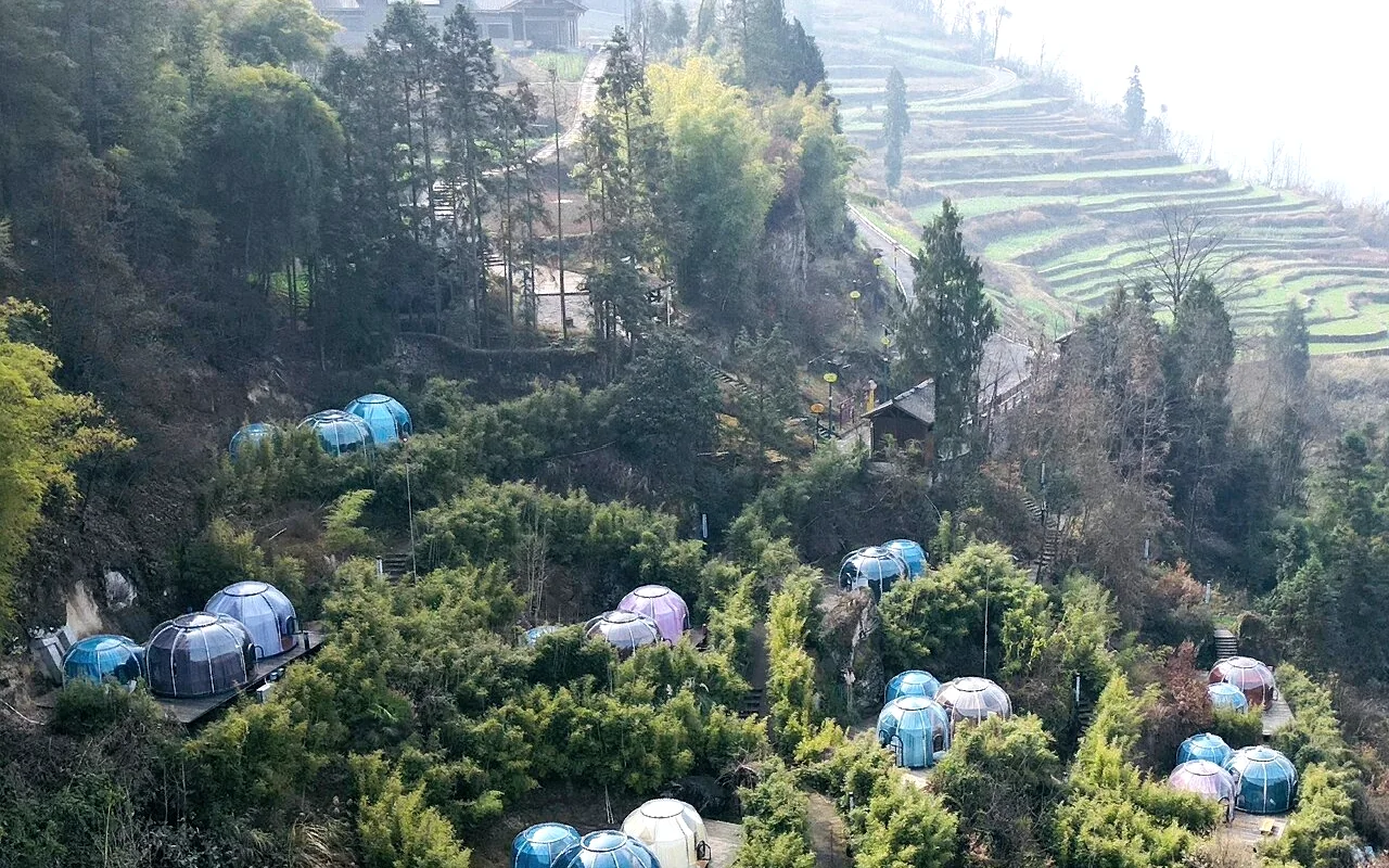 Aerial view of Celenest domes across a terraced hillside
