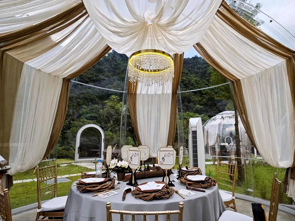 Table set for dining inside a Celenest dome with draped ceiling